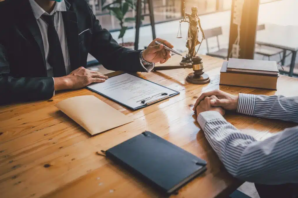 A man in a legal office explaining a contract agreement to another man
