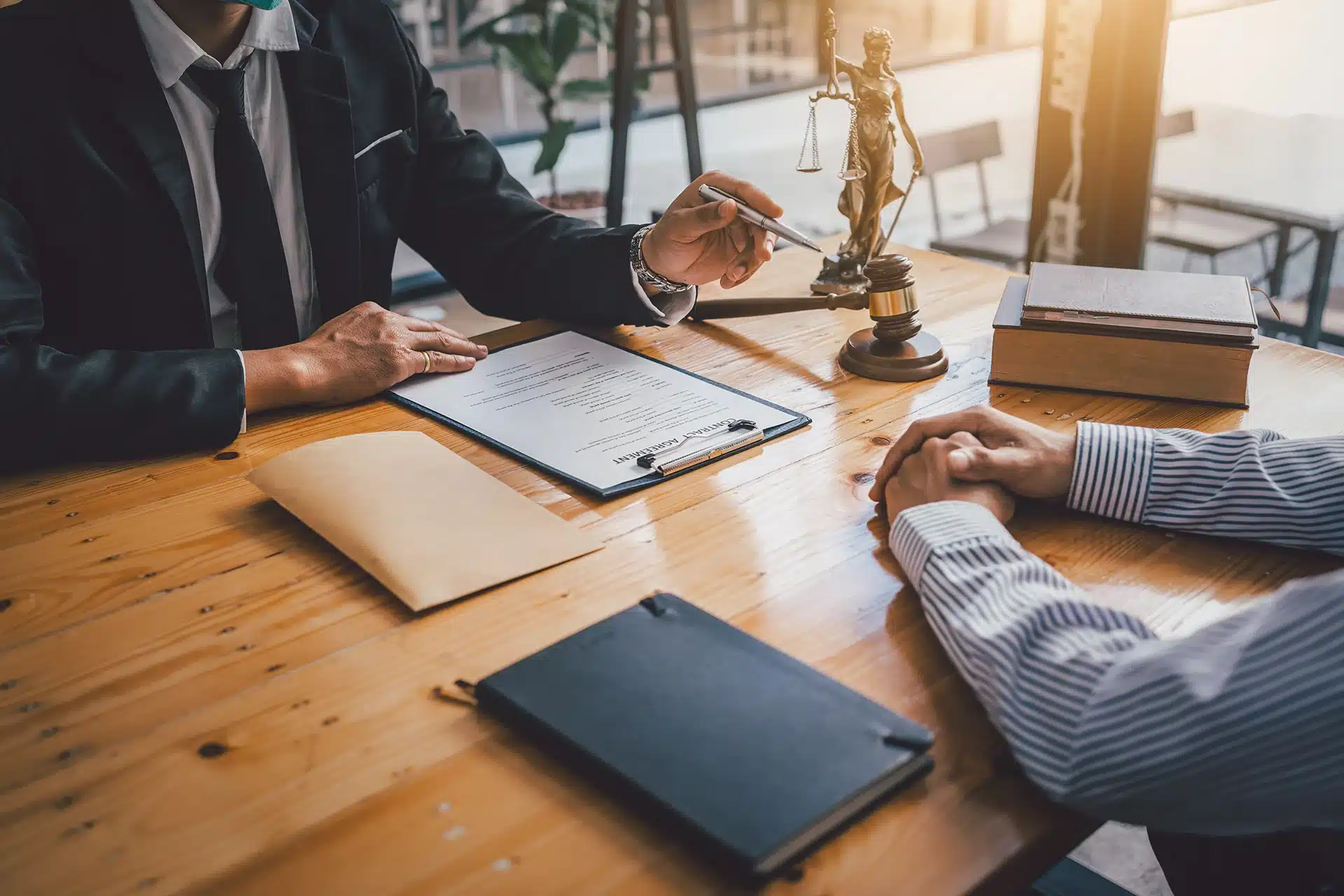 A man in a legal office explaining a contract agreement to another man