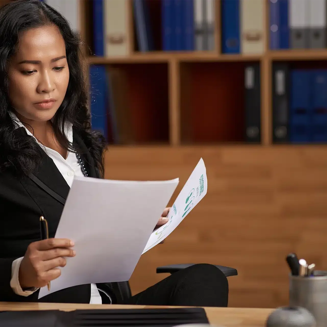 A legal arbitrator looking at documents at her desk