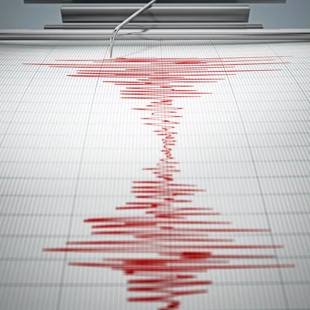 A white seismograph with red line recording seismic waves.