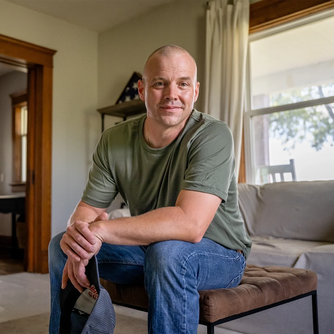 Veteran sitting on a chair in his living room