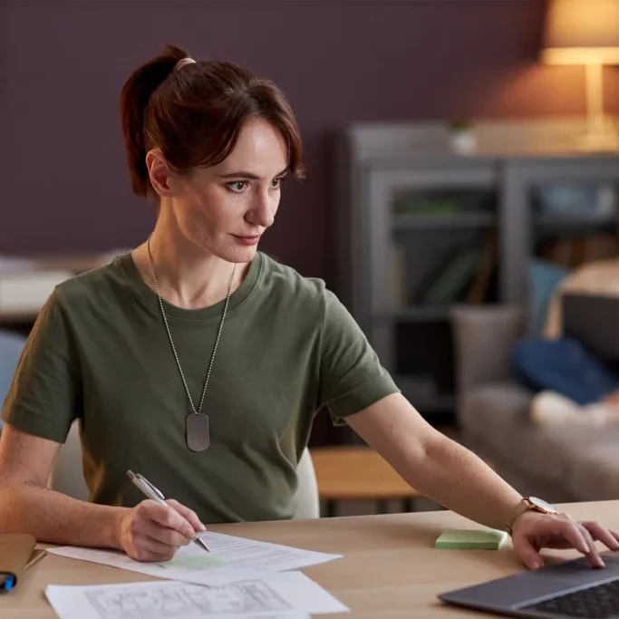 Veteran filling out paperwork while on the computer